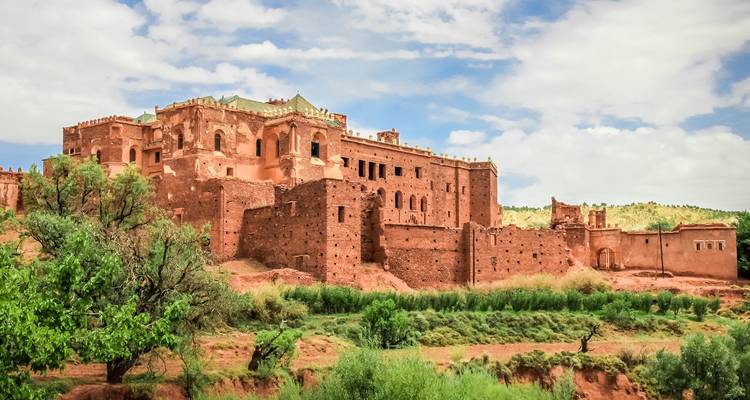 Historic fortress with lush greenery in the foreground.