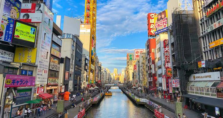 Cityscape with a canal and commercial buildings.