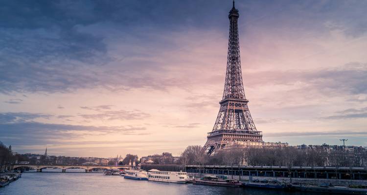 Eiffel Tower against a sunset sky.