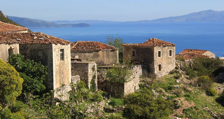 Stone ruins near the coast with a view of the sea.