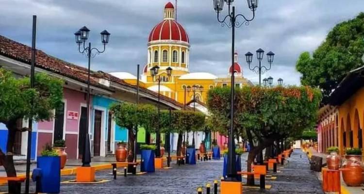 Colorful colonial street with a prominent dome.