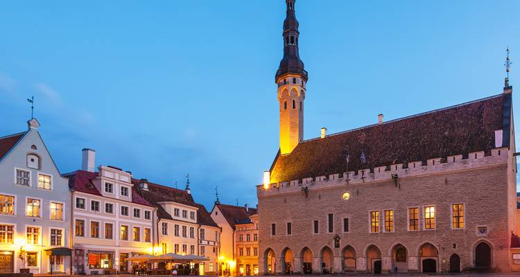 Historisches Gebäude und Turm auf einem alten Stadtplatz in der Dämmerung.
