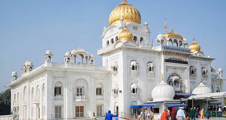 Een witte marmeren tempel met gouden koepels.