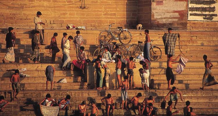 People on stone steps by the river, Varanasi, India.