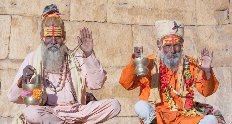 Elderly men with traditional face paint and attire.