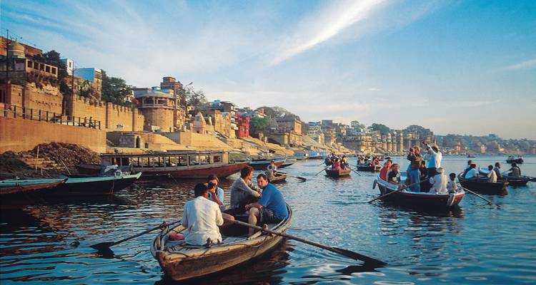 Boats on the Ganges River with people during daytime.