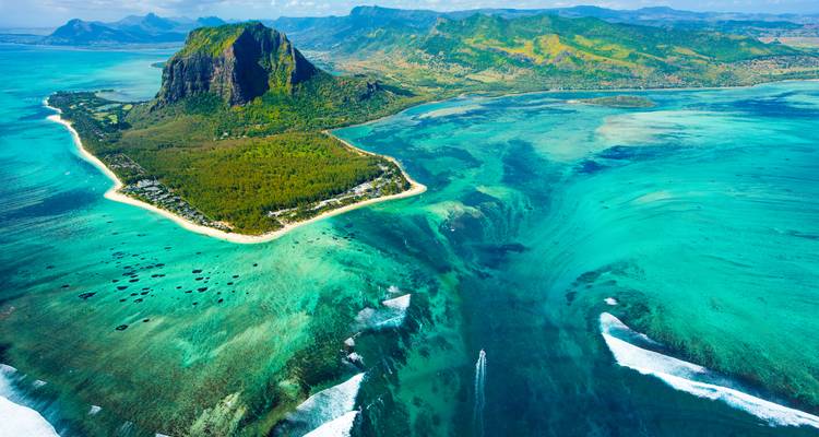 Aerial view of a mountain landscape with a turquoise sea.