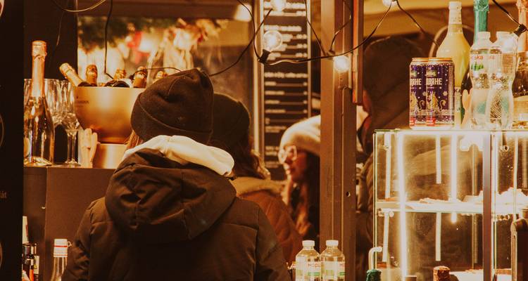 Inside a market with people and lights.