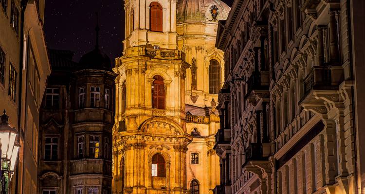 Historic church building lit up at night.