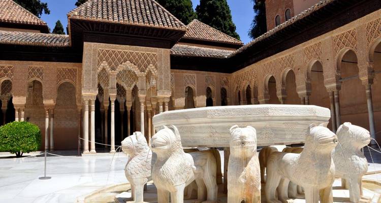 Palace courtyard with ornate arches and a central fountain.