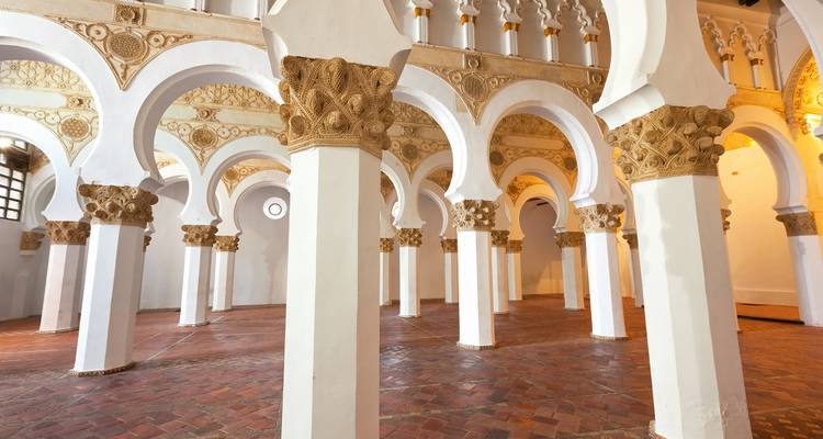 Interior with arches and intricate designs on pillars.