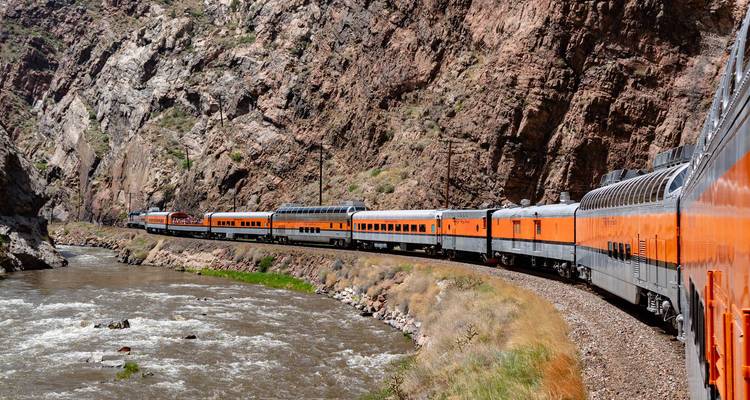Train voyageant à travers un canyon rocheux pittoresque.
