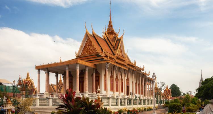 Elegant golden-roofed throne hall of Phnom Penh’s Royal Palace shining under a blue sky.