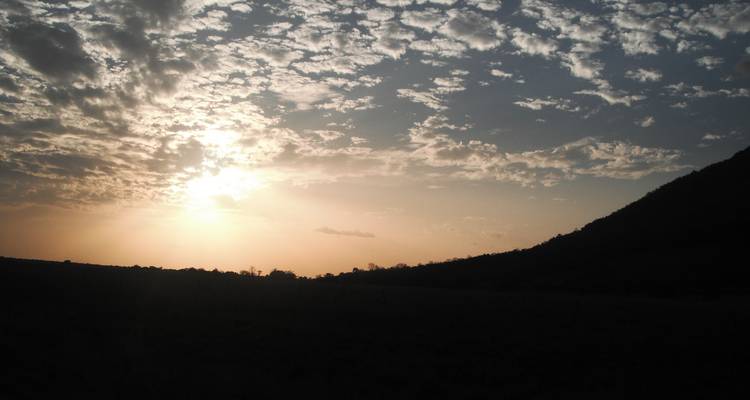 Silhouette of a mountain landscape at sunset.