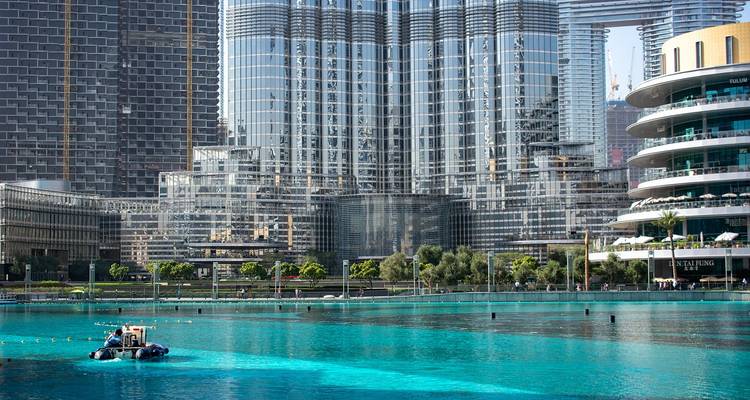 High-rise buildings beside a clear blue body of water.