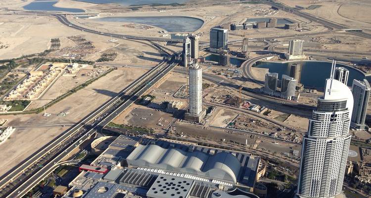 Aerial view of modern cityscape with complex road networks.
