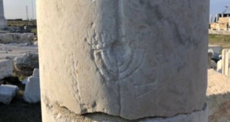 Stone with carved symbols.