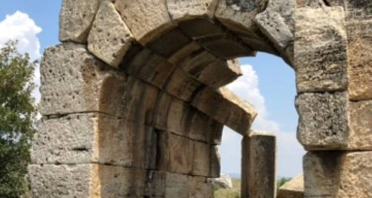 Arched stone structure with blue skies in the background.
