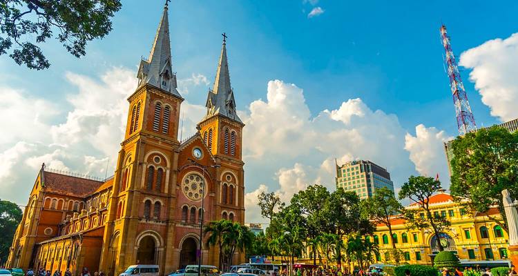 Front view of a historic cathedral with a clear sky and trees.