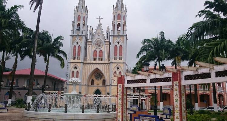 A decorative church with surrounding palm trees.