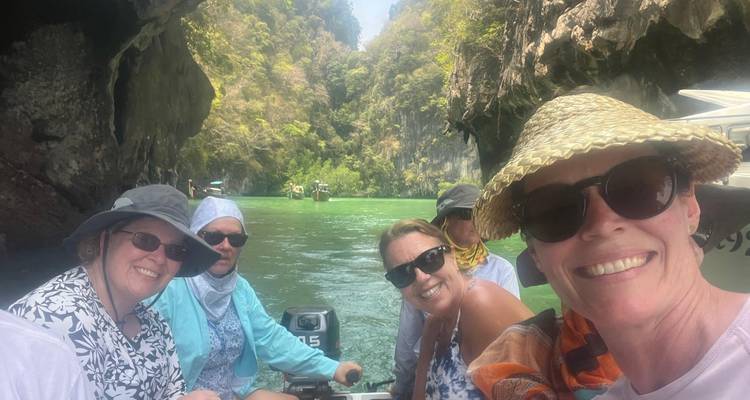 Groupe dans un bateau naviguant à travers une gorge calcaire.