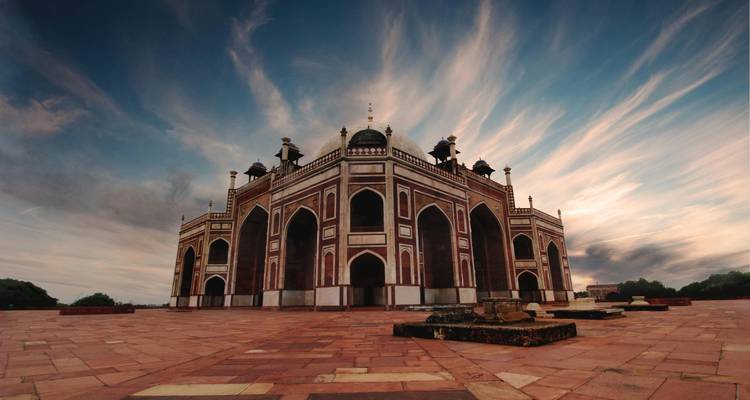 Humayun's Tomb under a dramatic sky.