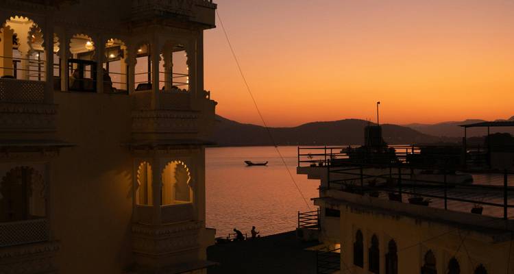 Sunset view from a balcony overlooking water.