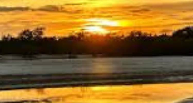 Coucher de soleil sur une étendue d'eau calme avec des reflets