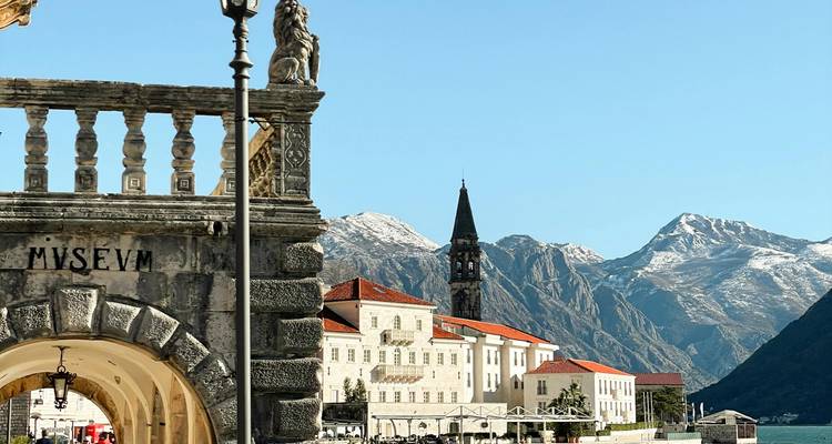 Historical building with mountainous landscape in the background.