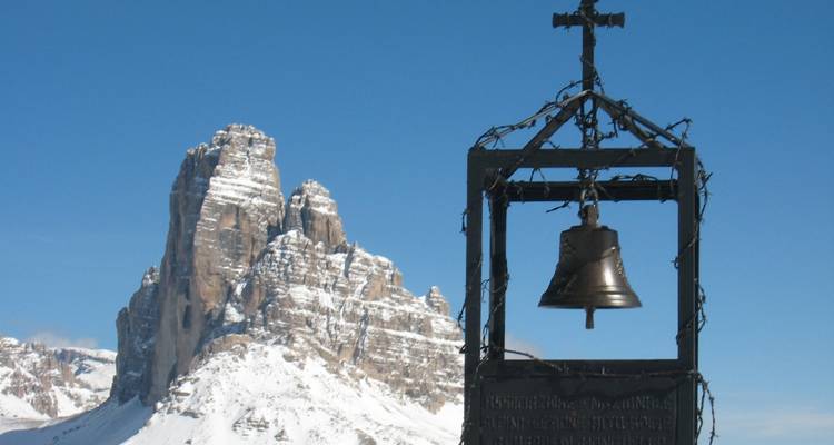 Bell structure with a mountain peak in the distance.