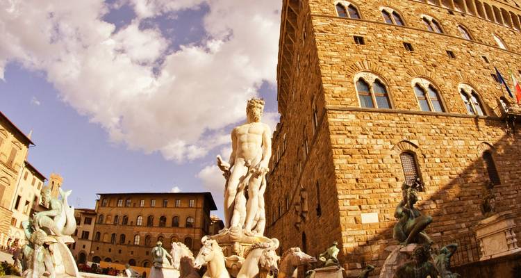 Statue in Piazza della Signoria with historic building.