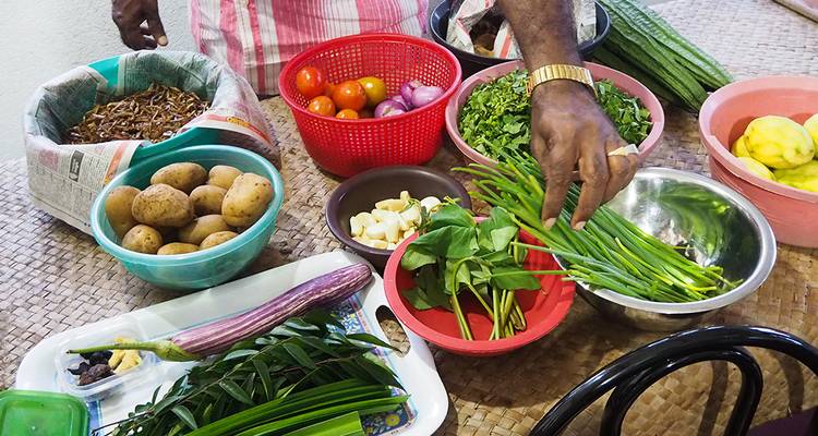 Divers ingrédients frais en cours de préparation dans une cuisine.
