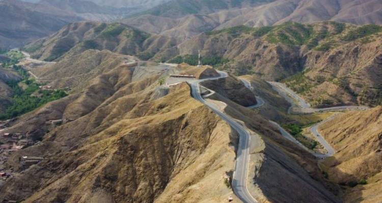 Una carretera serpenteante de montaña con paisaje árido.