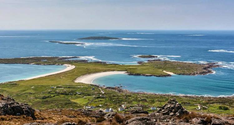 Aerial view of curved sandy beaches and small islands surrounded by turquoise Atlantic waters.