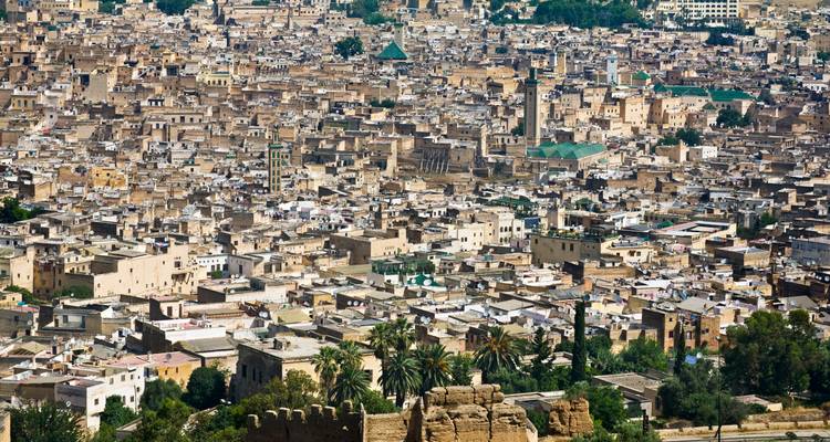 Aerial view of a densely packed cityscape with historic buildings and landmarks.