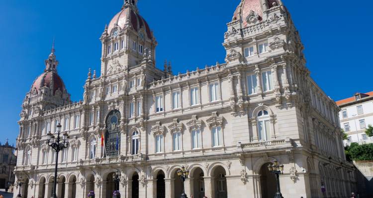 A historic neoclassical building with ornate architecture and clear blue sky.