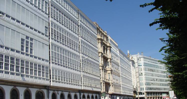 A row of tall buildings with glass-paneled facades.