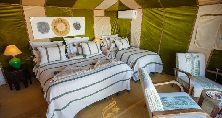 Interior of a tent with beds and decor.