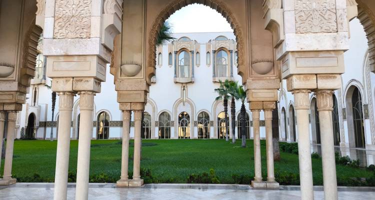Cour avec arcs en pierre et herbe.