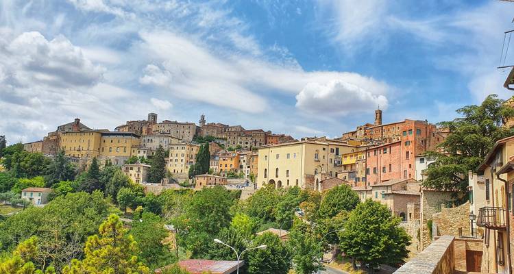 Hillside town view in Tuscany with old buildings.
