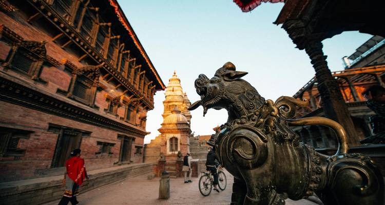A detailed close-up of a carved stone sculpture in a traditional architectural setting.