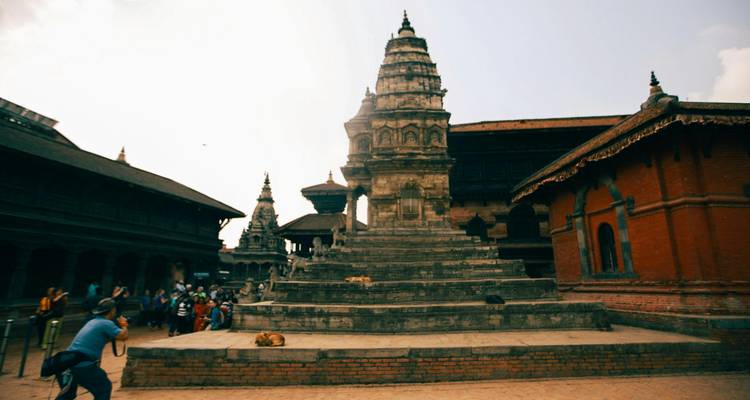 A historical temple with statues on its steps.