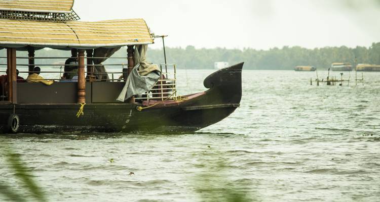 Front of a houseboat on a large body of water.