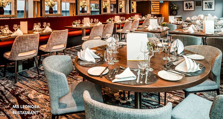 Restaurant in einem Kreuzfahrtschiff mit gedeckten Tischen zum Speisen.