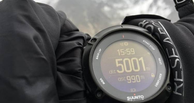 Close-up of a wristwatch showing elevation and time.