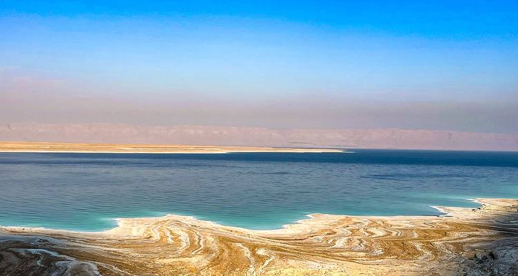 Scenic view of the Dead Sea shoreline with mineral formations.
