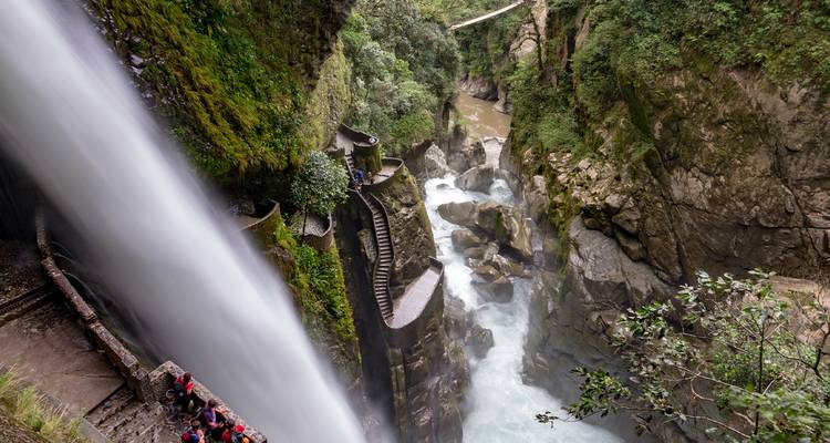 Series of waterfalls with a walkway and tourists.