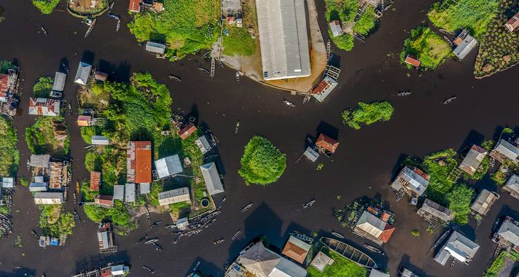 Aerial view of a village with interwoven waterways and greenery.
