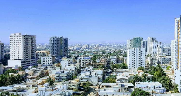 Moderne Skyline von Karachi mit Gruppen von Hochhäusern unter einem klaren blauen Himmel.