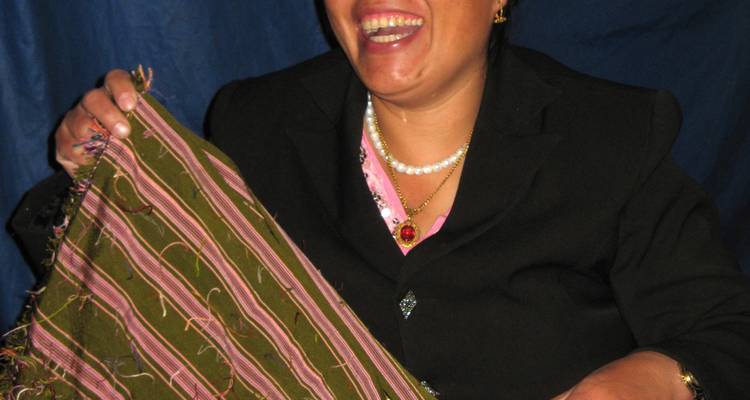 Person displaying a handmade textile.